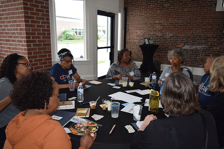 community members sit around a table at the steering committee meeting