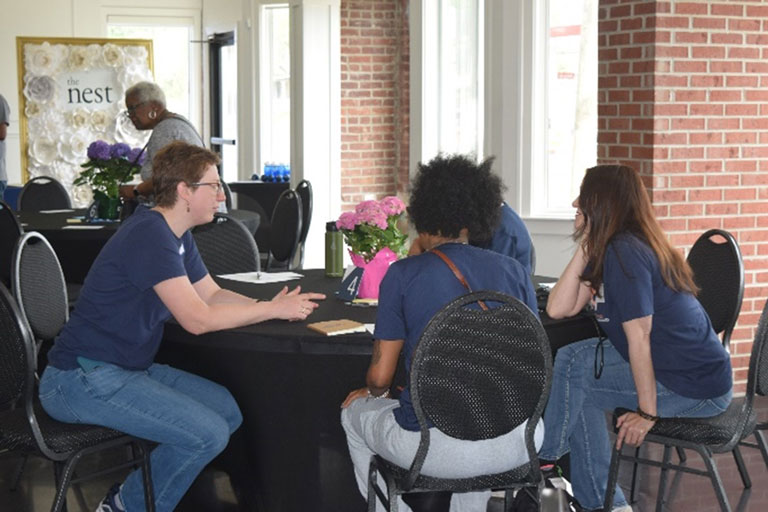 table discussion among community members at the steering committee meeting